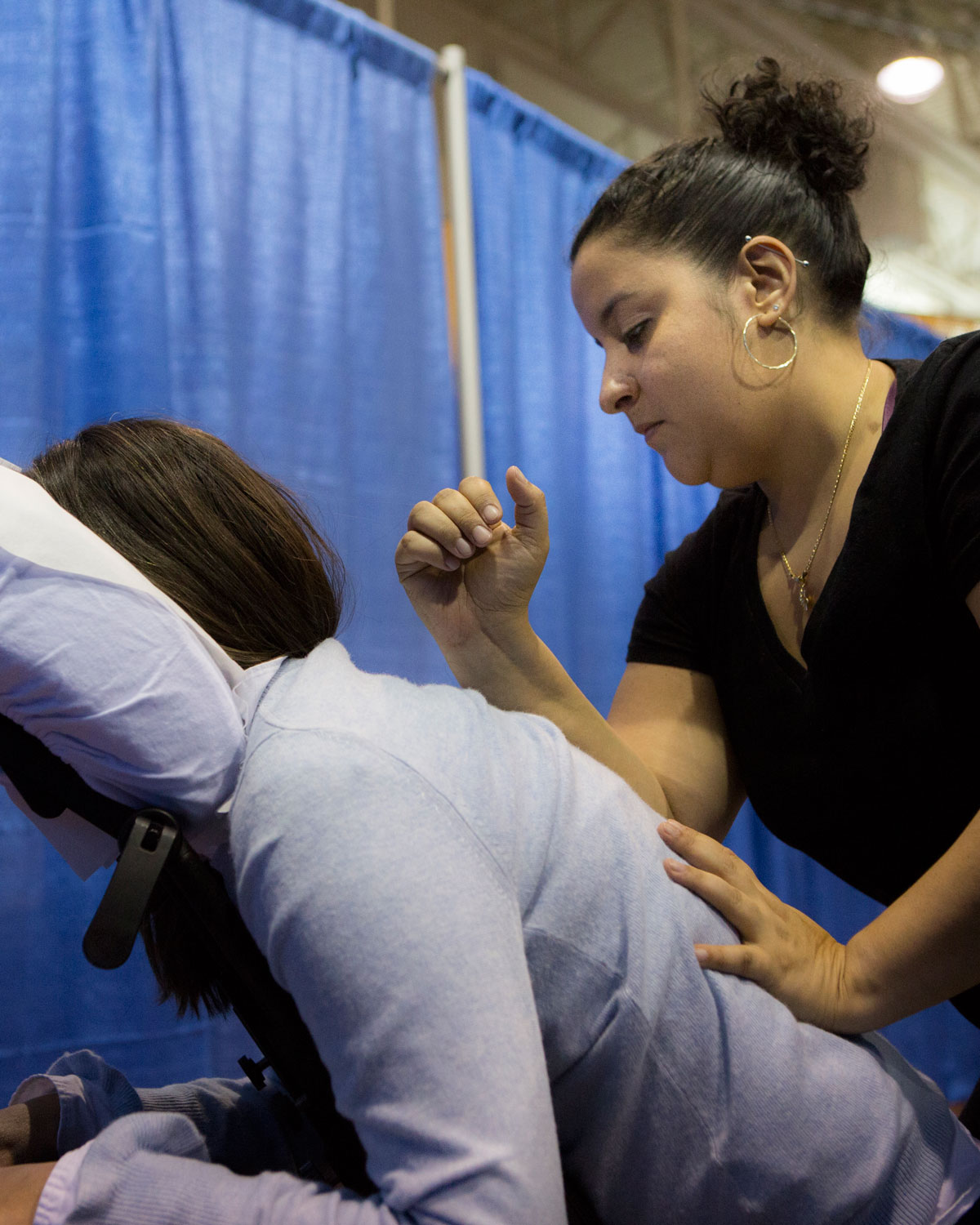 Employee sits in a chair and receives a professional massage during the annual benefits fair.